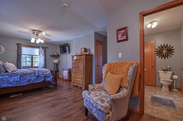 429 Bridge Ave, Warren, MN 56762 - bedroom with a textured ceiling, wood finished floors, connected bathroom, and a ceiling fan