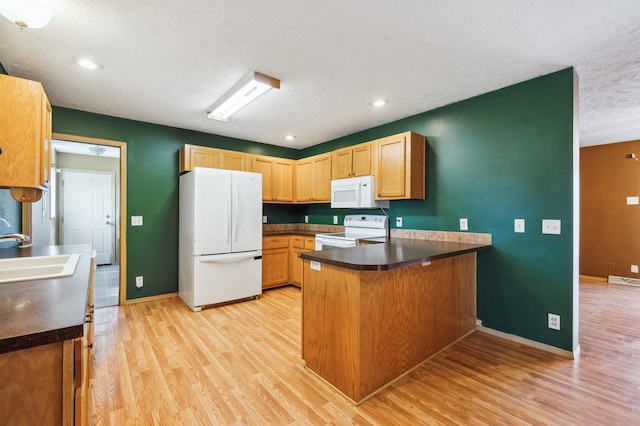 63219 Great River Rd, Jacobson, MN 55752 - kitchen with kitchen peninsula, a textured ceiling, white appliances, sink, and light hardwood / wood-style flooring