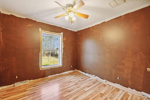 63219 Great River Rd, Jacobson, MN 55752 - empty room featuring a textured ceiling, light hardwood / wood-style floors, and ceiling fan