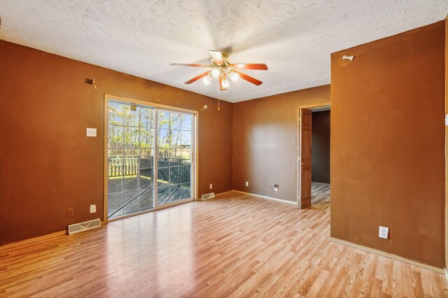 63219 Great River Rd, Jacobson, MN 55752 - spare room featuring a textured ceiling, light wood-type flooring, and ceiling fan