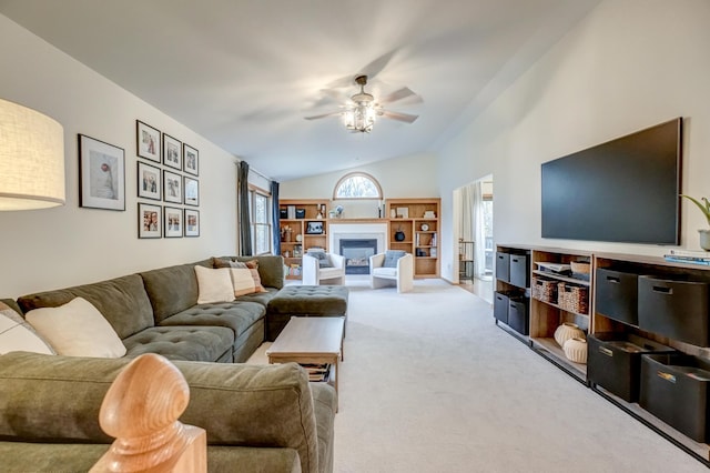 living room featuring vaulted ceiling, ceiling fan, and carpet flooring