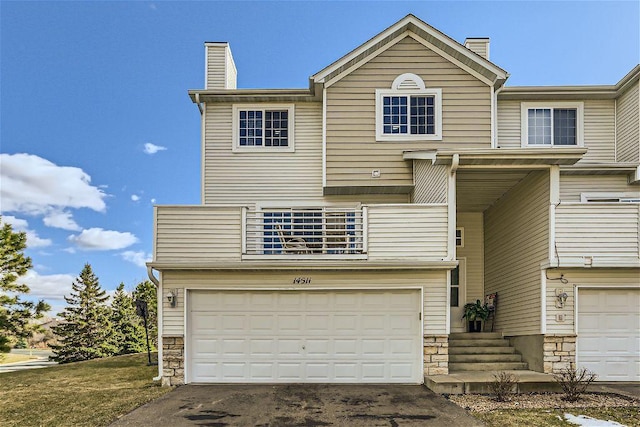 multi unit property featuring a balcony and a garage