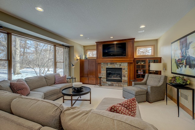 carpeted living room with a textured ceiling and a fireplace