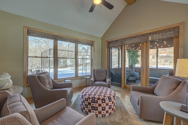 interior space featuring lofted ceiling with beams, ceiling fan, and light wood-type flooring