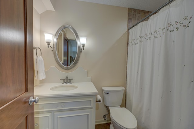 bathroom featuring vanity, toilet, and a textured ceiling