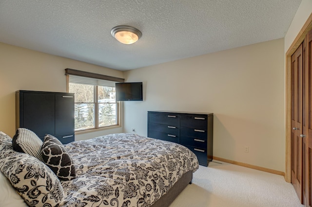 carpeted bedroom featuring a textured ceiling