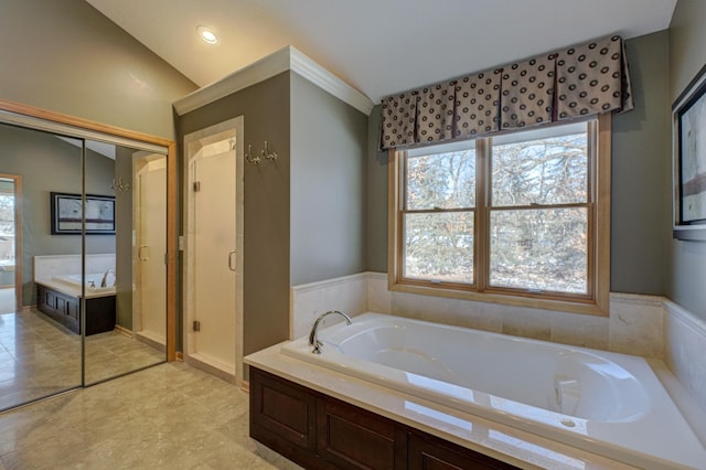 bathroom featuring separate shower and tub and vaulted ceiling