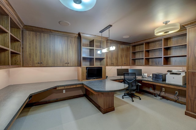 office with light carpet and built in desk