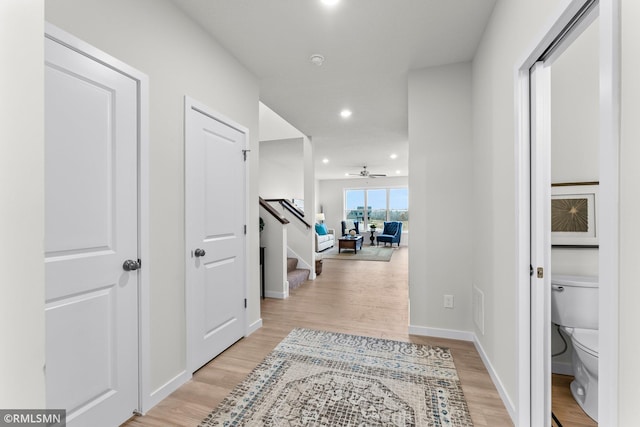 hallway with light hardwood / wood-style flooring