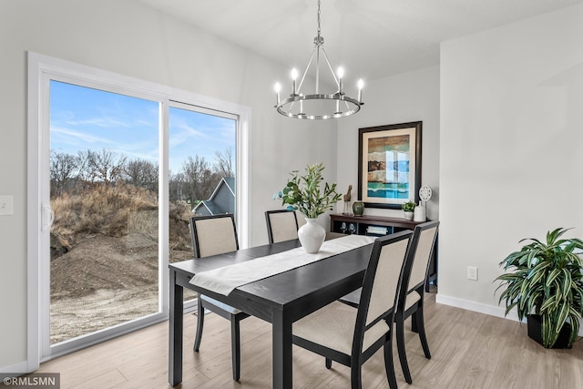 dining area featuring a chandelier and light wood-type flooring