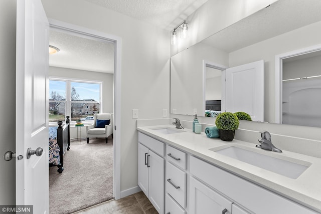 bathroom with vanity and a textured ceiling