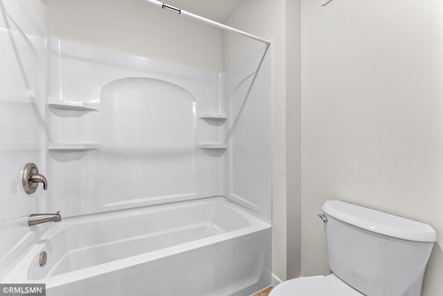 bathroom featuring bathtub / shower combination and toilet