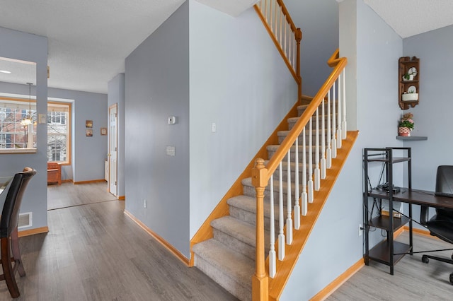 stairway featuring hardwood / wood-style floors