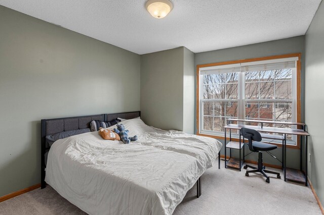 carpeted bedroom featuring a textured ceiling