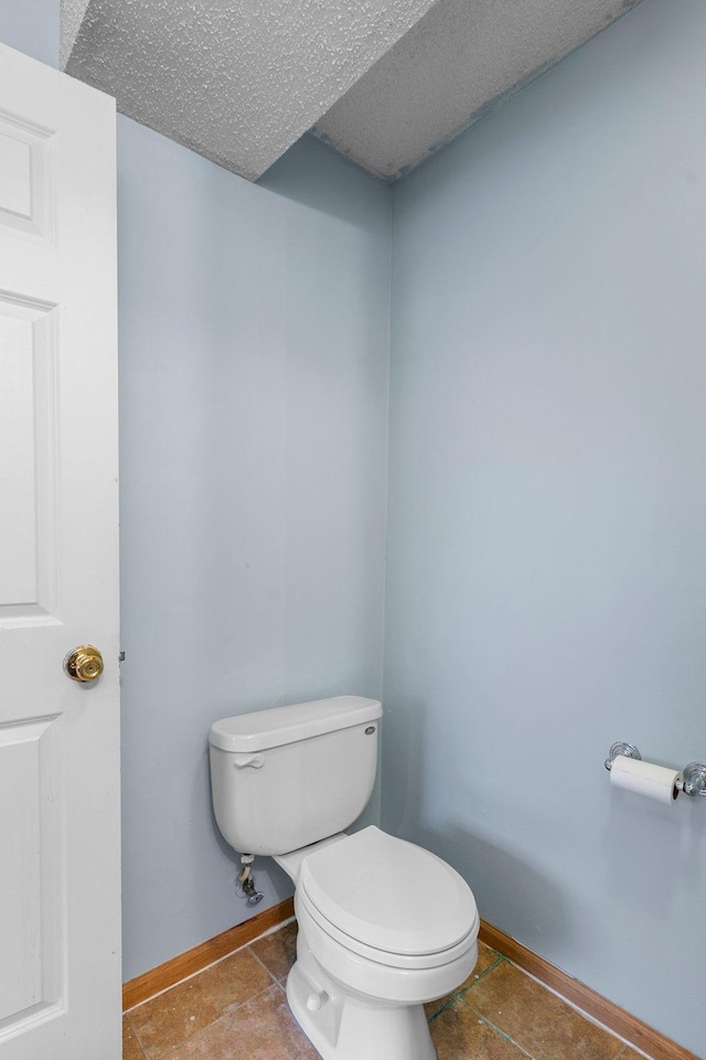 bathroom featuring toilet and a textured ceiling