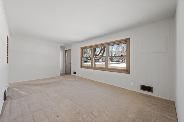 unfurnished room with light colored carpet