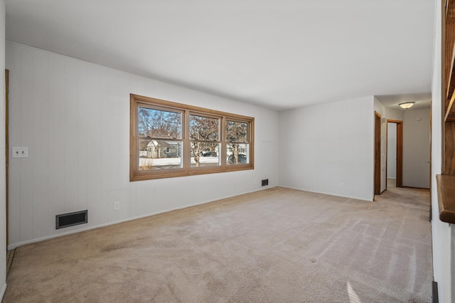 unfurnished room featuring light carpet