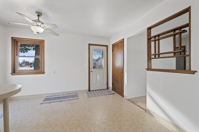 carpeted entrance foyer with ceiling fan