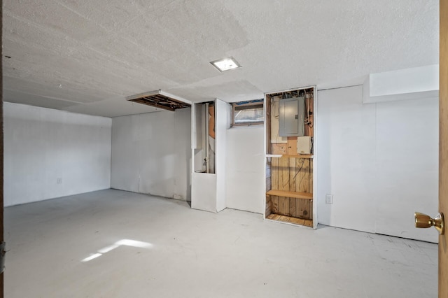 basement with electric panel and a textured ceiling