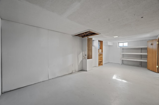 basement featuring a textured ceiling