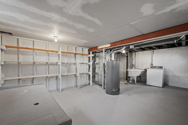 basement featuring sink, gas water heater, and washer / dryer