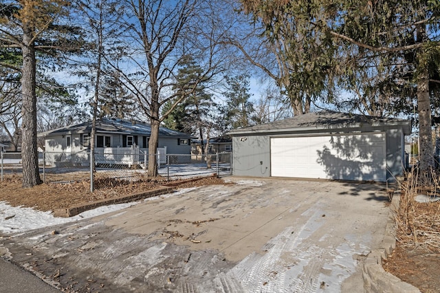 view of front facade featuring a garage and an outbuilding