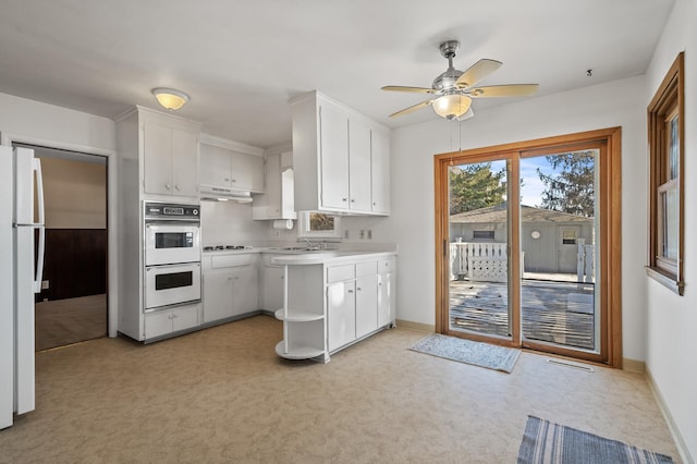 kitchen with white cabinets, ceiling fan, white appliances, and light carpet