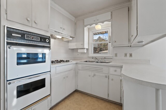 kitchen featuring sink, white appliances, white cabinets, and ornamental molding