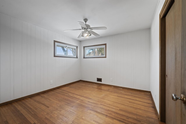 empty room featuring ceiling fan and wood-type flooring