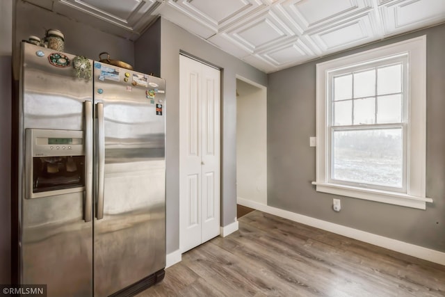 kitchen with hardwood / wood-style flooring, stainless steel refrigerator with ice dispenser, and coffered ceiling