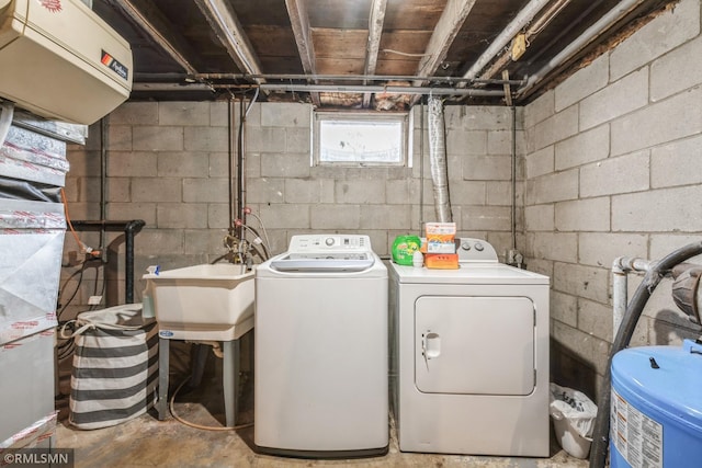 laundry area with washing machine and dryer and sink