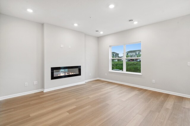 unfurnished living room featuring light hardwood / wood-style flooring