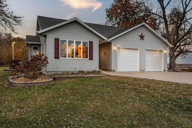 ranch-style home featuring an attached garage, concrete driveway, and a front yard