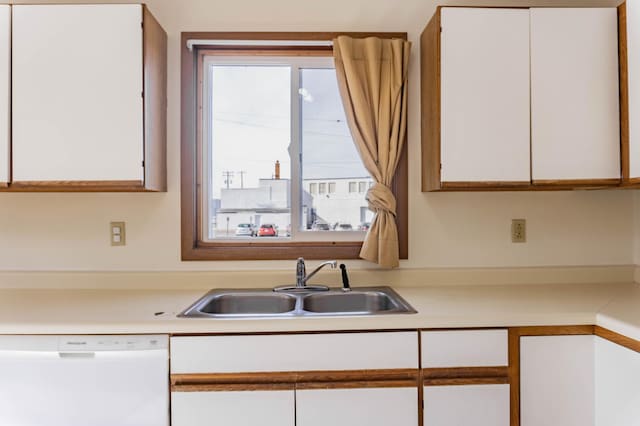 kitchen featuring dishwasher, plenty of natural light, and white cabinetry