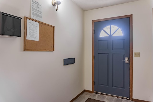 entryway featuring hardwood / wood-style floors and a textured ceiling