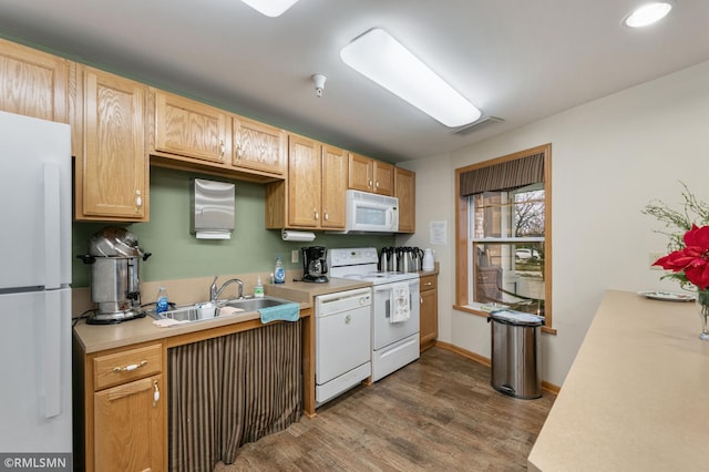 kitchen with dark hardwood / wood-style floors, sink, and white appliances