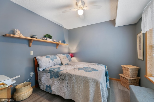 bedroom featuring hardwood / wood-style floors and ceiling fan