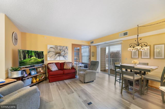 5650 Boone Ave N Unit 321, New Hope, MN 55428 - living room featuring wood finished floors and a chandelier