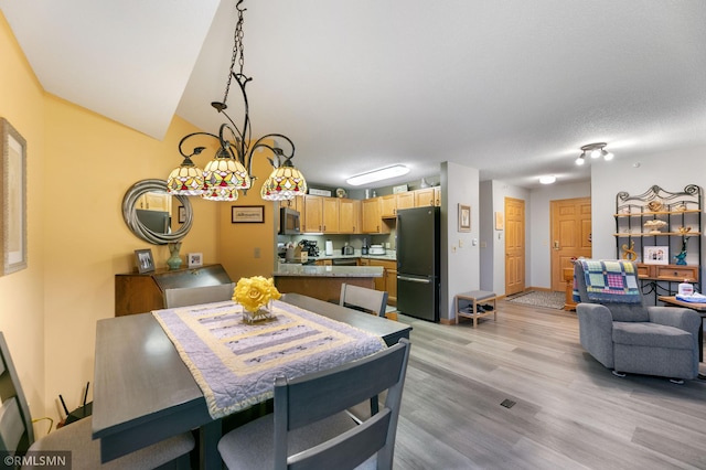 5650 Boone Ave N Unit 321, New Hope, MN 55428 - dining area with light wood-style floors