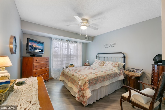 5650 Boone Ave N Unit 321, New Hope, MN 55428 - bedroom with wood finished floors, a ceiling fan, and a textured ceiling