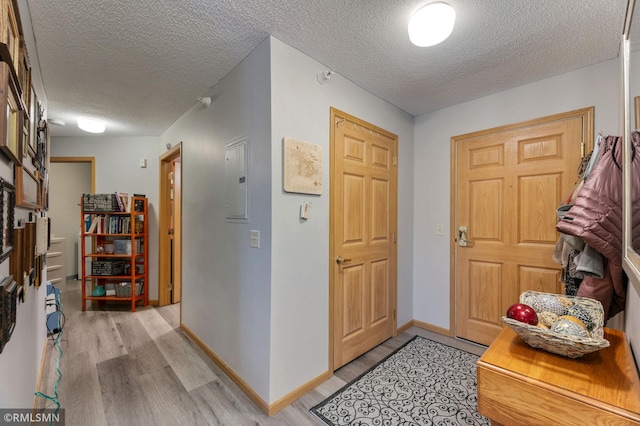 5650 Boone Ave N Unit 321, New Hope, MN 55428 - entrance foyer featuring light wood-style flooring, a textured ceiling, electric panel, and baseboards