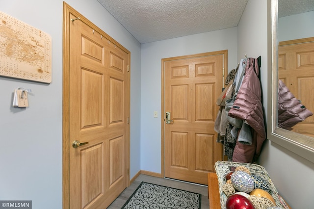 5650 Boone Ave N Unit 321, New Hope, MN 55428 - foyer featuring a textured ceiling and baseboards