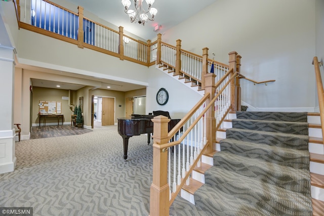 5650 Boone Ave N Unit 321, New Hope, MN 55428 - staircase with carpet flooring, a towering ceiling, baseboards, and a chandelier