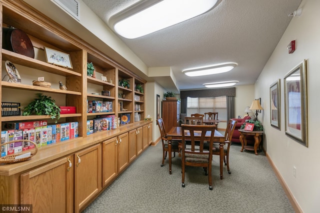 5650 Boone Ave N Unit 321, New Hope, MN 55428 - dining space featuring a textured ceiling, carpet flooring, and baseboards