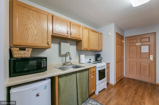 5650 Boone Ave N Unit 321, New Hope, MN 55428 - kitchen featuring white electric range oven, black microwave, a sink, refrigerator, and wood finished floors