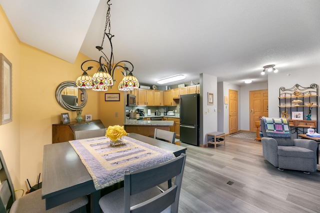 5650 Boone Ave N Unit 321, New Hope, MN 55428 - dining area featuring light wood-type flooring