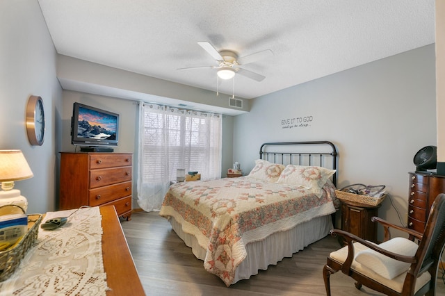 5650 Boone Ave N Unit 321, New Hope, MN 55428 - bedroom with wood finished floors, ceiling fan, and a textured ceiling