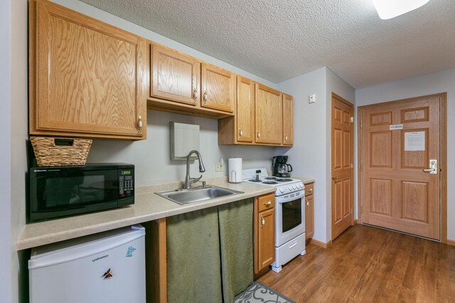 5650 Boone Ave N Unit 321, New Hope, MN 55428 - kitchen featuring electric stove, refrigerator, black microwave, wood finished floors, and light countertops
