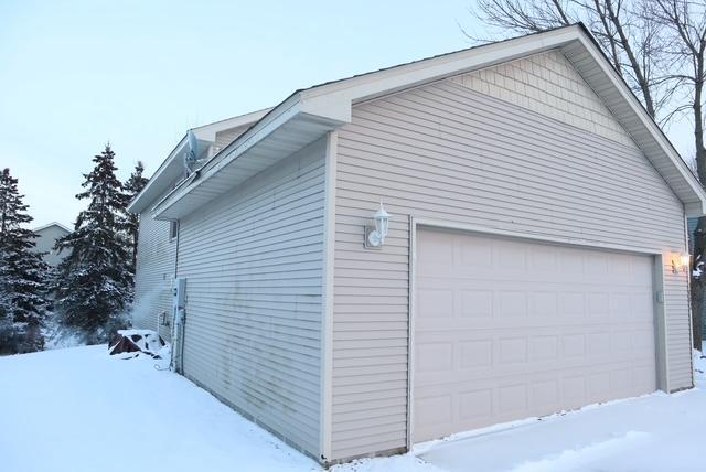 view of snowy exterior with a garage