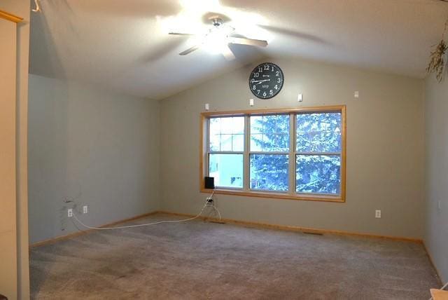 unfurnished room featuring carpet, ceiling fan, and vaulted ceiling